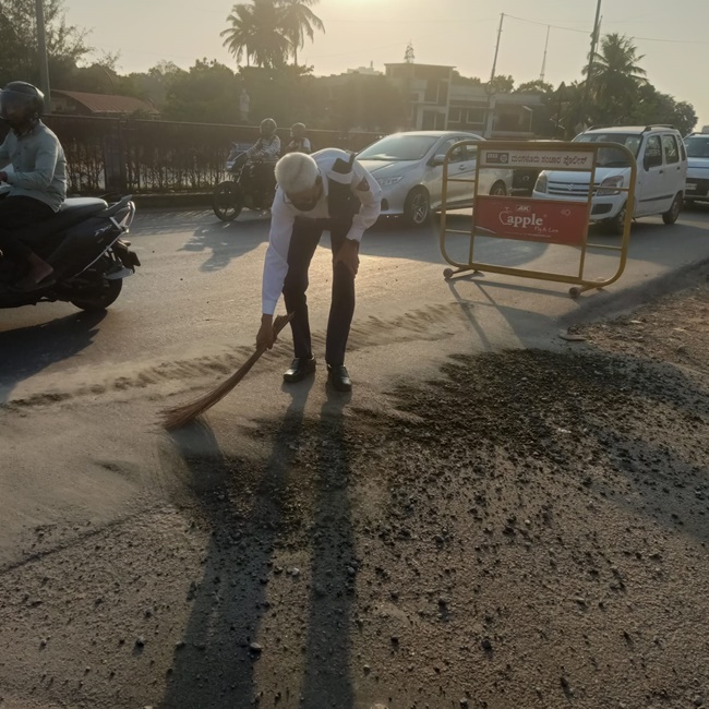Readymix truck spills concrete on national highway: Francis Maxim Moraes sweeps and cleans the stree