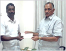 Minister Abayachandra Jain hands over Rs 1 lac cheque to Ace Swimmer Gopal Karvi