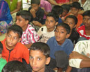 Mangalore: South Block Congress distributes free books and rain-wear to school children